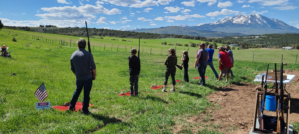 Five on the line for shooting moving clay targets with shotguns